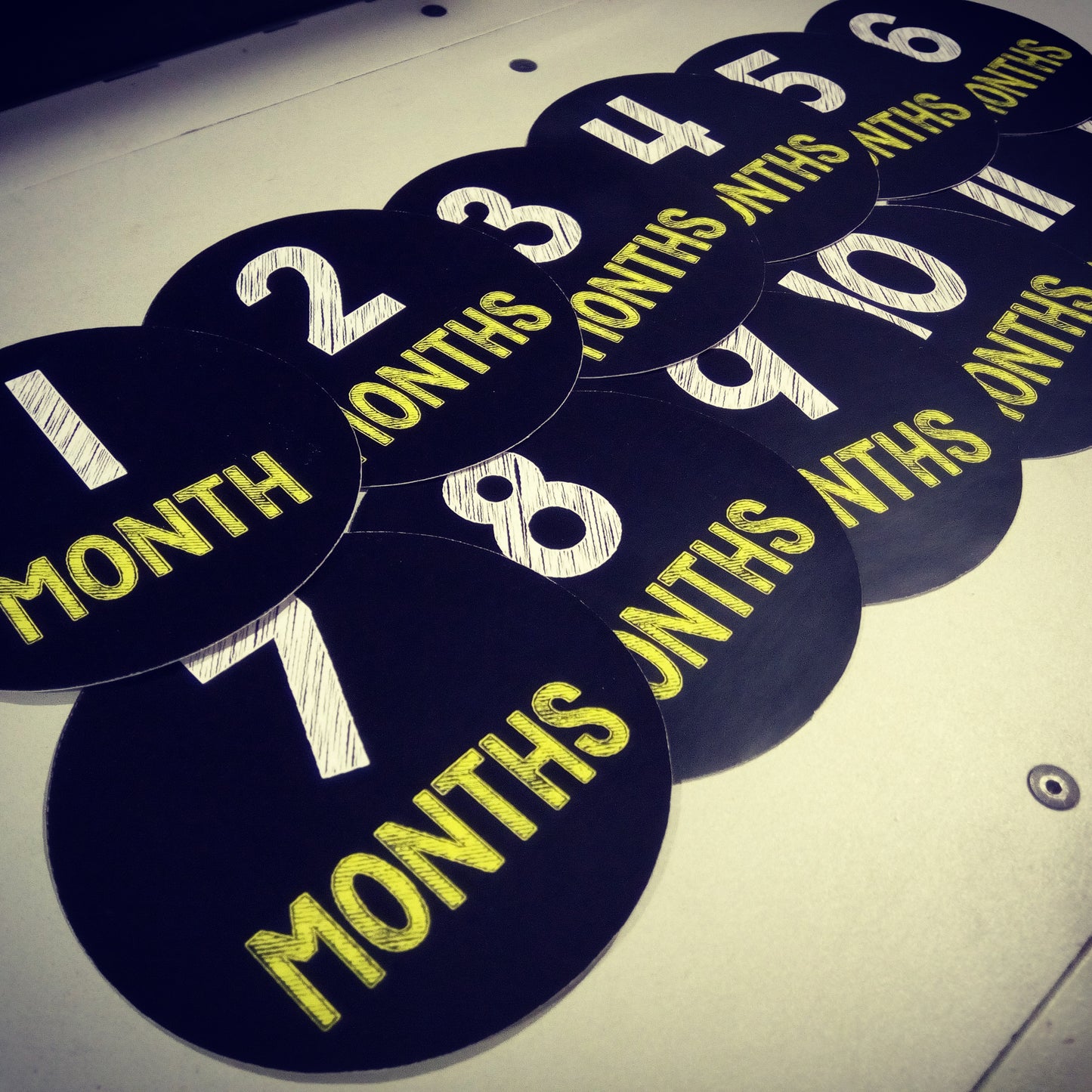 Monthly baby stickers. Simple black and yellow chalk bodysuit infants month labels