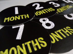 Monthly baby stickers. Simple black and yellow chalk bodysuit infants month labels