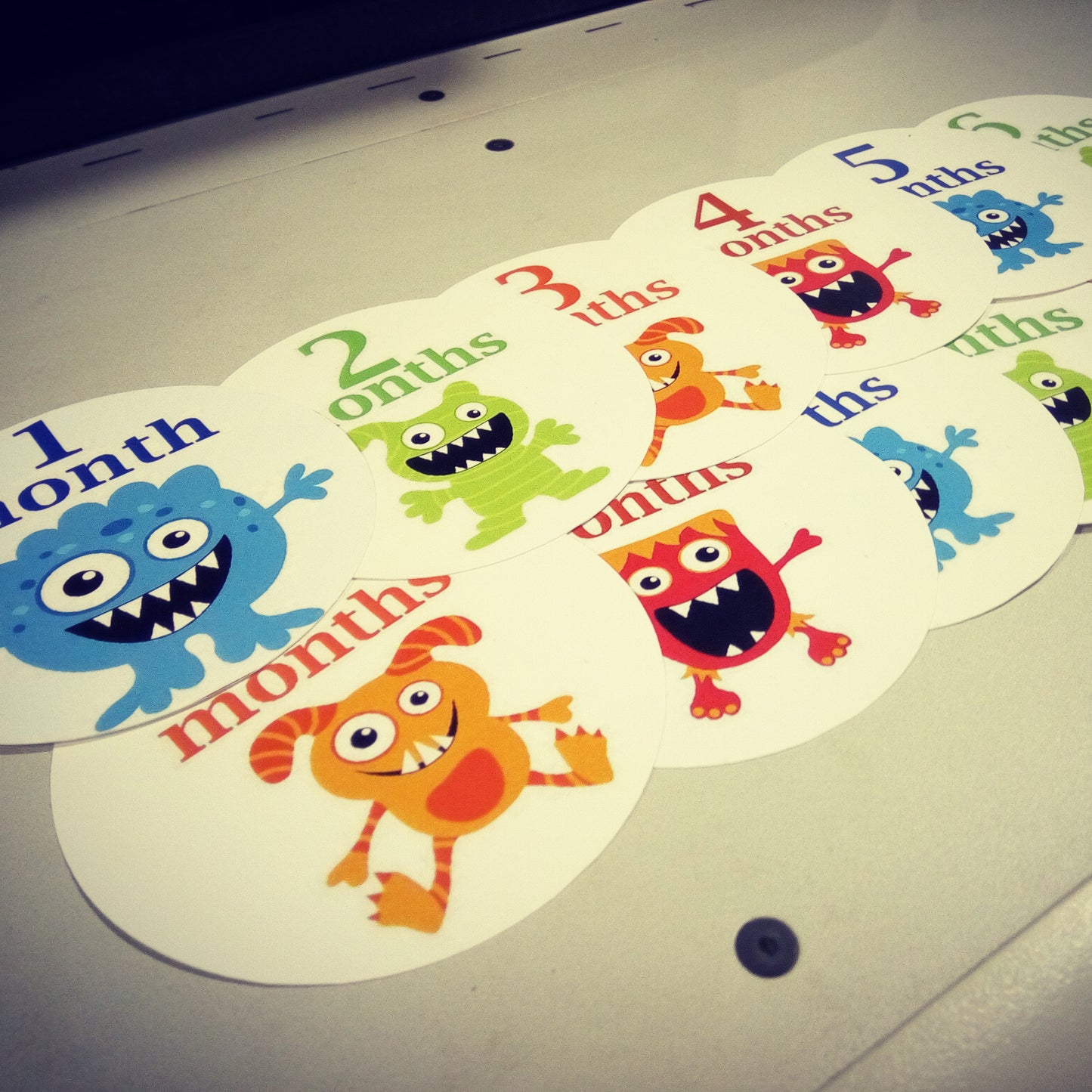 Monthly baby stickers. Cute monsters bodysuit infants month labels.
